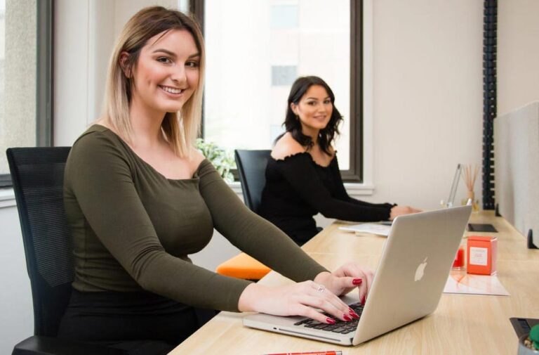 spot coworking laptops girls closeup